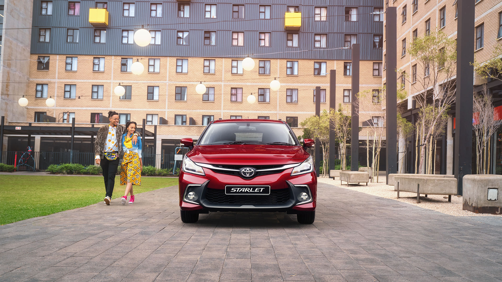 happy Toyota Starlet owners walking in the city