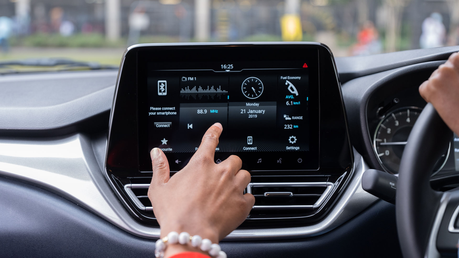 person using toyota starlet touchscreen display