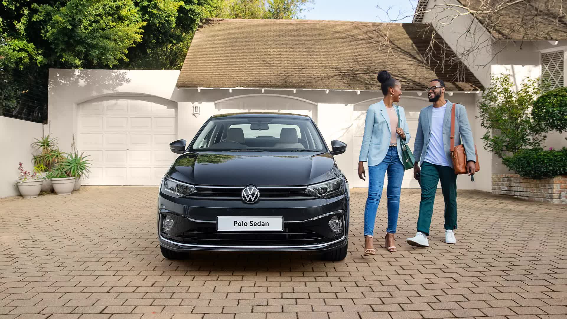 Black-VW-Polo-Sedan-Outside-With-Husband-and-Wife
