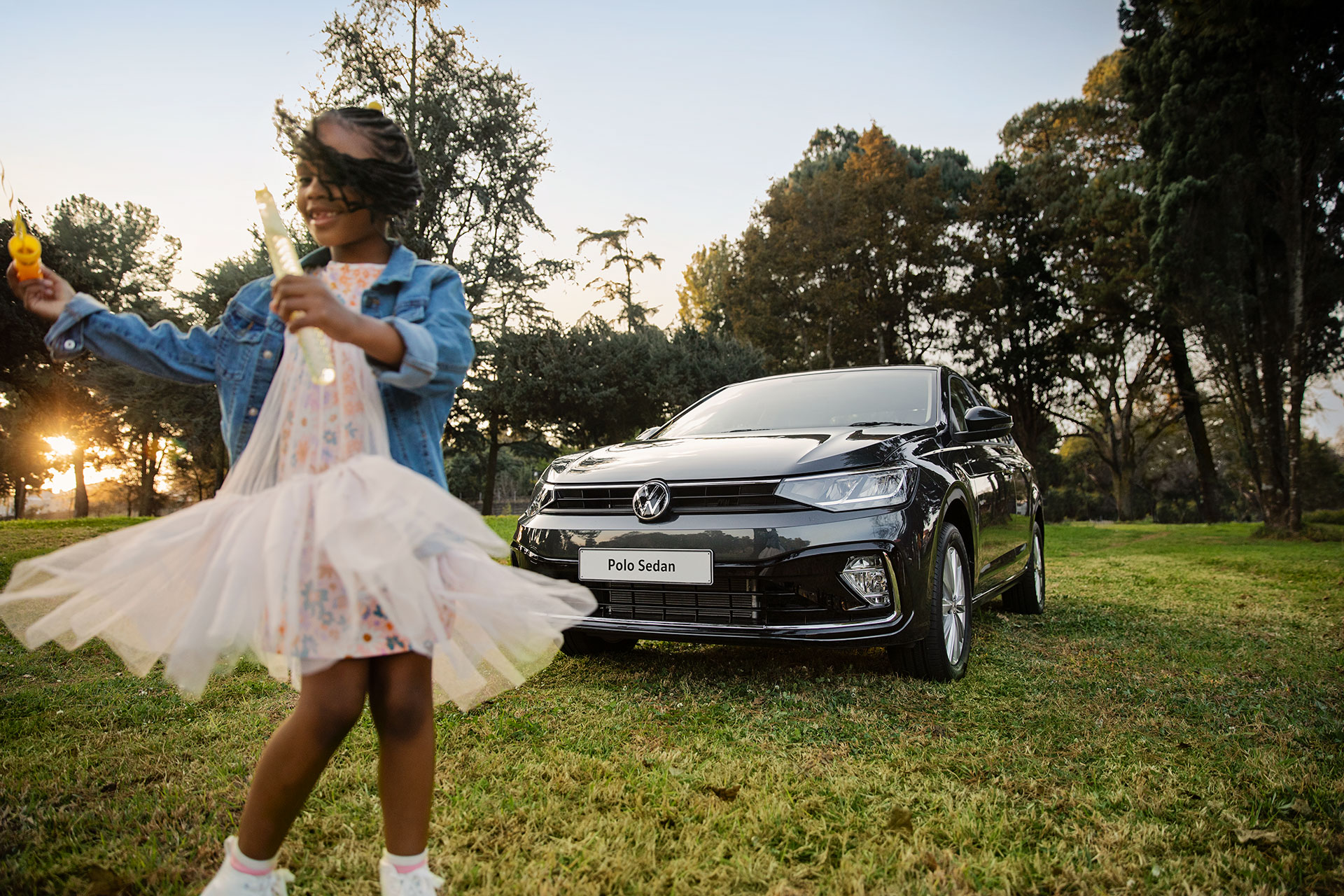 Black-Polo-Sedan-With-A-Child-Playing-Outdoor